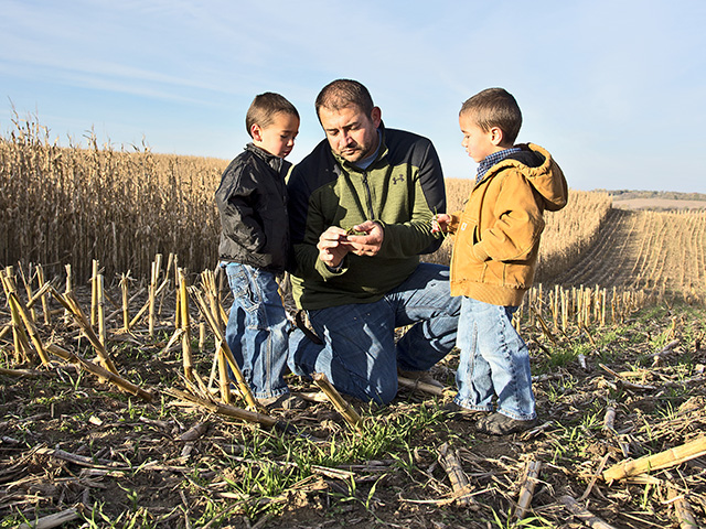 Kevin Ross is taking steps today to use practices that improve his land in hopes that one or all of his four sons (shown, Carver and Hollis) will want to take over the family farm. (DTN/The Progressive Farmer photo by Greg Lamp)